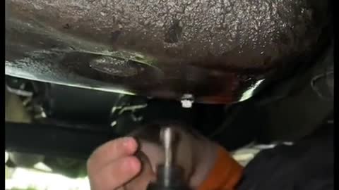 Daily routine of car oil draining and repairman