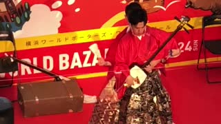 Playing a traditional Japanese musical instrument
