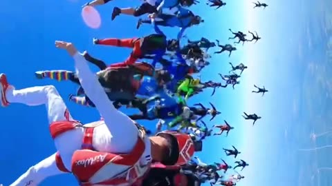 Group of skydivers meet to form an extraordinary view .