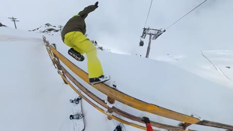 Guy Falls Onto the Snow Trying to Climb a Fence in a Ski Resort