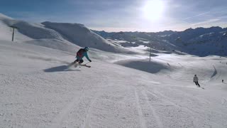 Downhill skiing quickly down the mountainl - man & camera