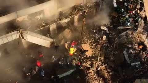 Dnipro: Rescuers search rubble after Russian attack on apartment block