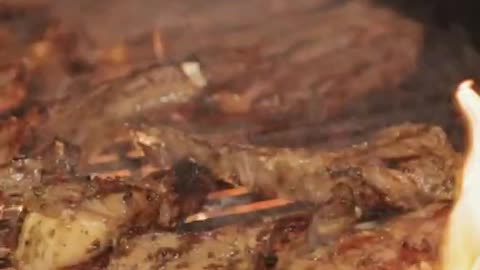 Sizzling Meat on Barbecue Close Up Slow Motion Video
