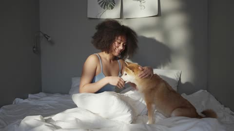 Giving Food to dog and playing with dog at the same time