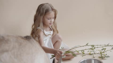 Young Girl Feeding the Goats