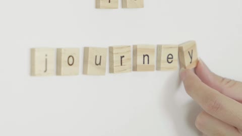 A Person Holding Scrabble Tiles