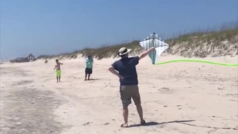 Guy releases kite into air, instantly flies back to hit him