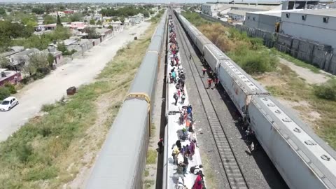 Illegal Aliens stand on the top of Trains as they head to the U.S. border in Eagle Pass, Texas