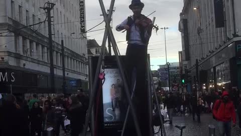 Play violin while tightrope walking