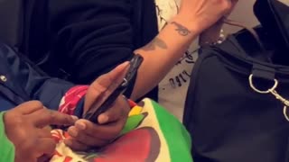 Girl on subway holding rat in her hand