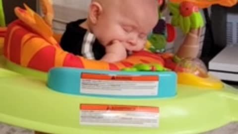 Tired baby literally falls asleep while bouncing in jumper