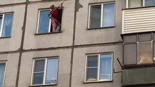 Woman Rescues Kitten Stuck in Window