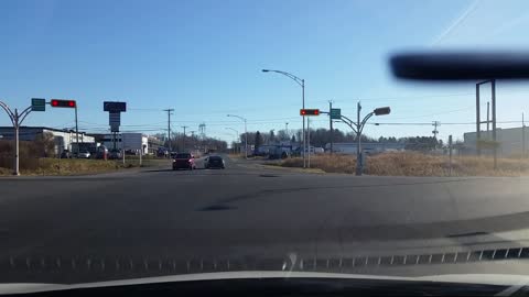 Driver randomly tosses soft drink at vehicle stopped at red light