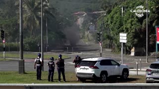 New Caledonia police patrol streets with burnt cars
