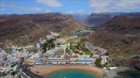 breathtaking aerial views of the gran canaria lomo city and the beach with yachts and canyon