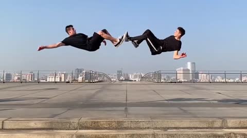 Guys Pull Off A Duet Backflip With Their Feet Touching Against Each