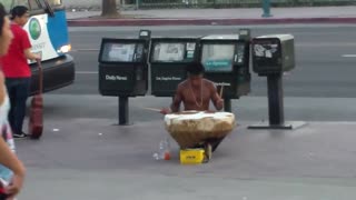 A street warrior musician play giant drum