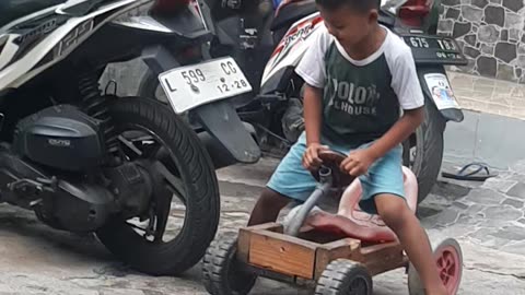 little boy playing with new a toy car