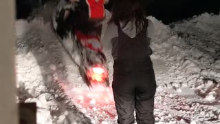 Snowmobile Kicks Snow Straight into Girlfriend