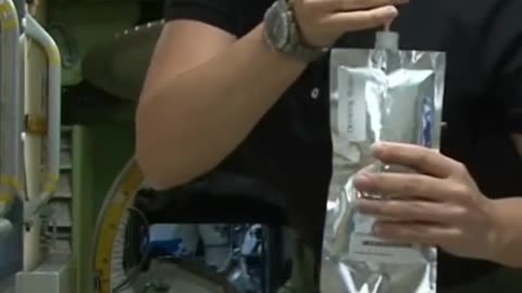 Astronaut drinking water at space station