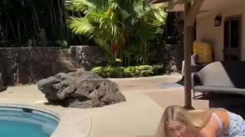 Woman is teaching her Golden Retriever how to surf!
