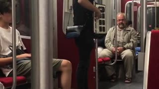 Guy playing accordion subway black clothes white shoes