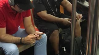 Guy white headphones dancing on subway seat black clothes