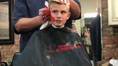 Barber pranks a kid pretending he cut his ear