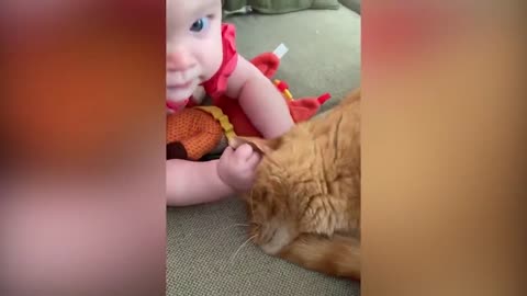 The baby sings to the cat