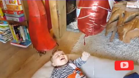 Baby Laughs at Balloons Are Tied to Hands and Feet
