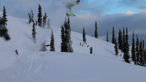 Snowmobile Rider Slips During Stunt