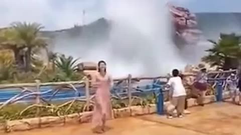 lady trying to get a selfie gets wiped out by a water jet.