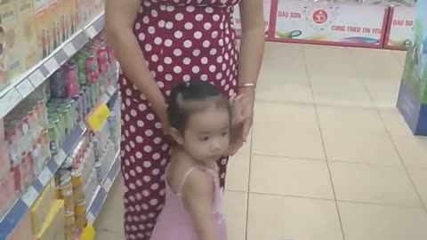 The girl goes to the market to buy things with her grandmother