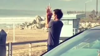 Guy does meditation poses at the beach, flute music