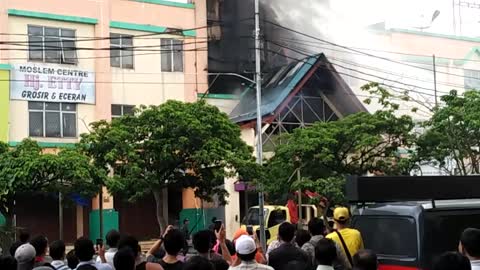 Fireman struggle to put out burning building