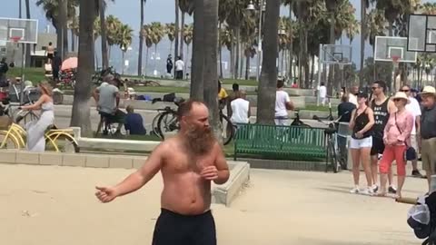 Guy shirtless beach dancing boxing with door