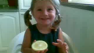 Toddler tries a lemon for the first time