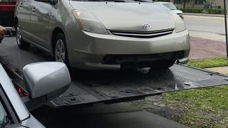 Tow Truck Driver Send Car Rolling Into Garage Door