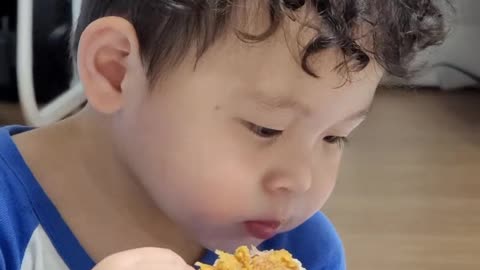 Eating chicken for a cute baby