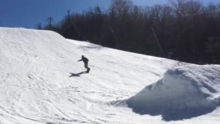 Purple jacket snowboard buttslide