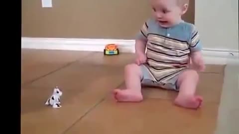 Funny cute baby scared by toy cow
