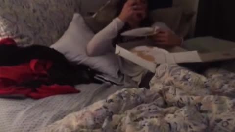 Drunk girl eating pizza in bed