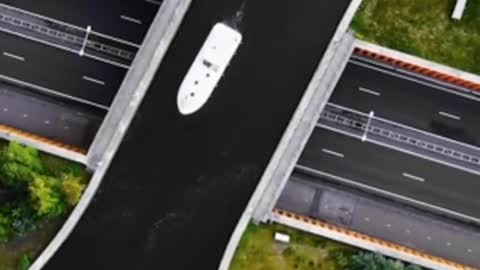 Drone Footage: 'Disappearing' bridge carries boats across Dutch motorway