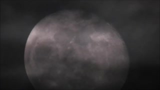 Moon rising through the clouds