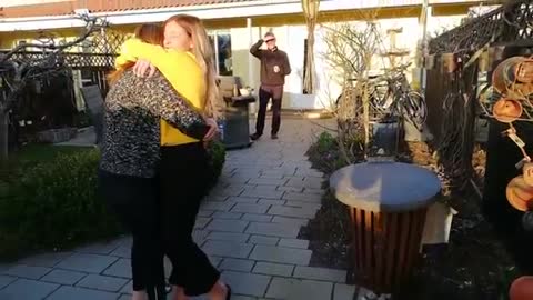 woman surprises loved ones