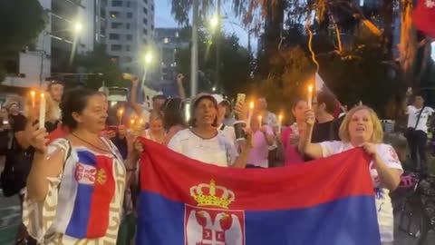 Novak Djokovic supporters outside Park Hotel dance, sing, hold candles on Orthodox Xmas Eve