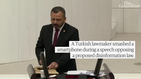 Turkish lawmaker smashes phone with hammer during speech