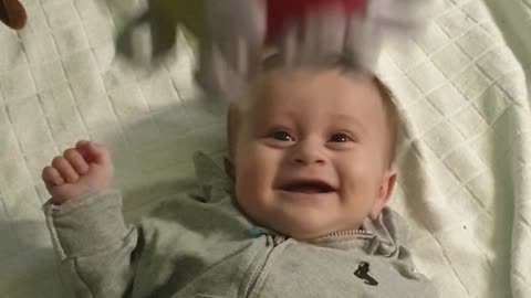 Baby Boy Adorably Cracks Up Every Time Toy Ball Is Dropped On Him