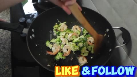Cooking Stir fried broccoli with shrimp in a hot pan