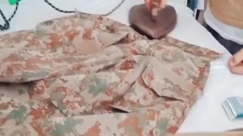 Army persion make his uniform perfect with iron